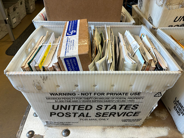 letters and packages in USPS bin